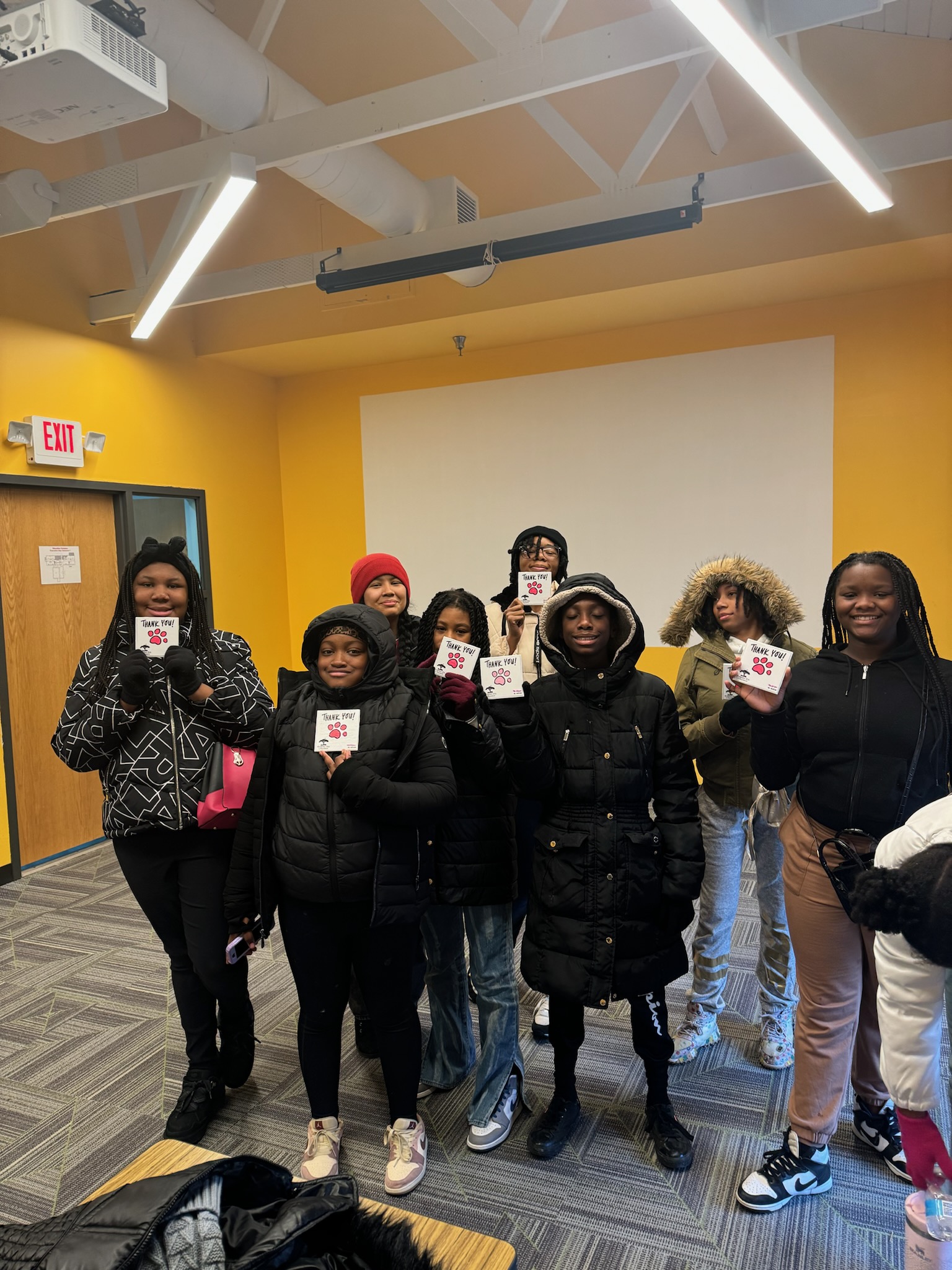 People holding thank you note